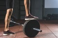 Cropped image of sportsman standing on barbell Royalty Free Stock Photo